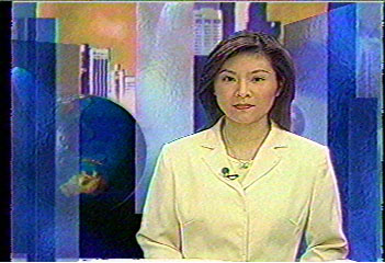 Here's Luk Siu-man again, just arrived from the desk to the chromakey wall. Whoever does the news that evening also does business news.